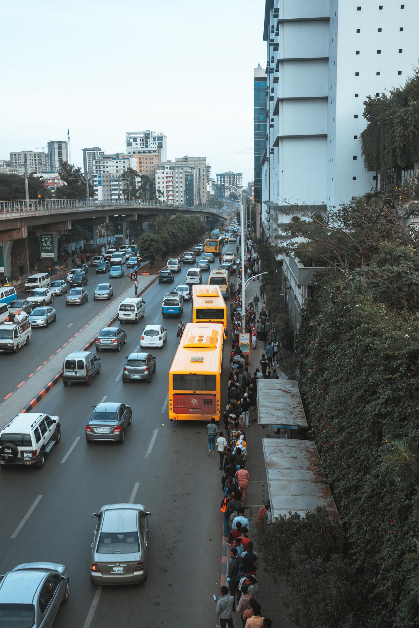 A Long Queue of People Waiting to Board a Bus